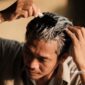 Seorang pria mewarnai rambut beruban dengan cat rambut warna hitam - sukabumiheadline.com